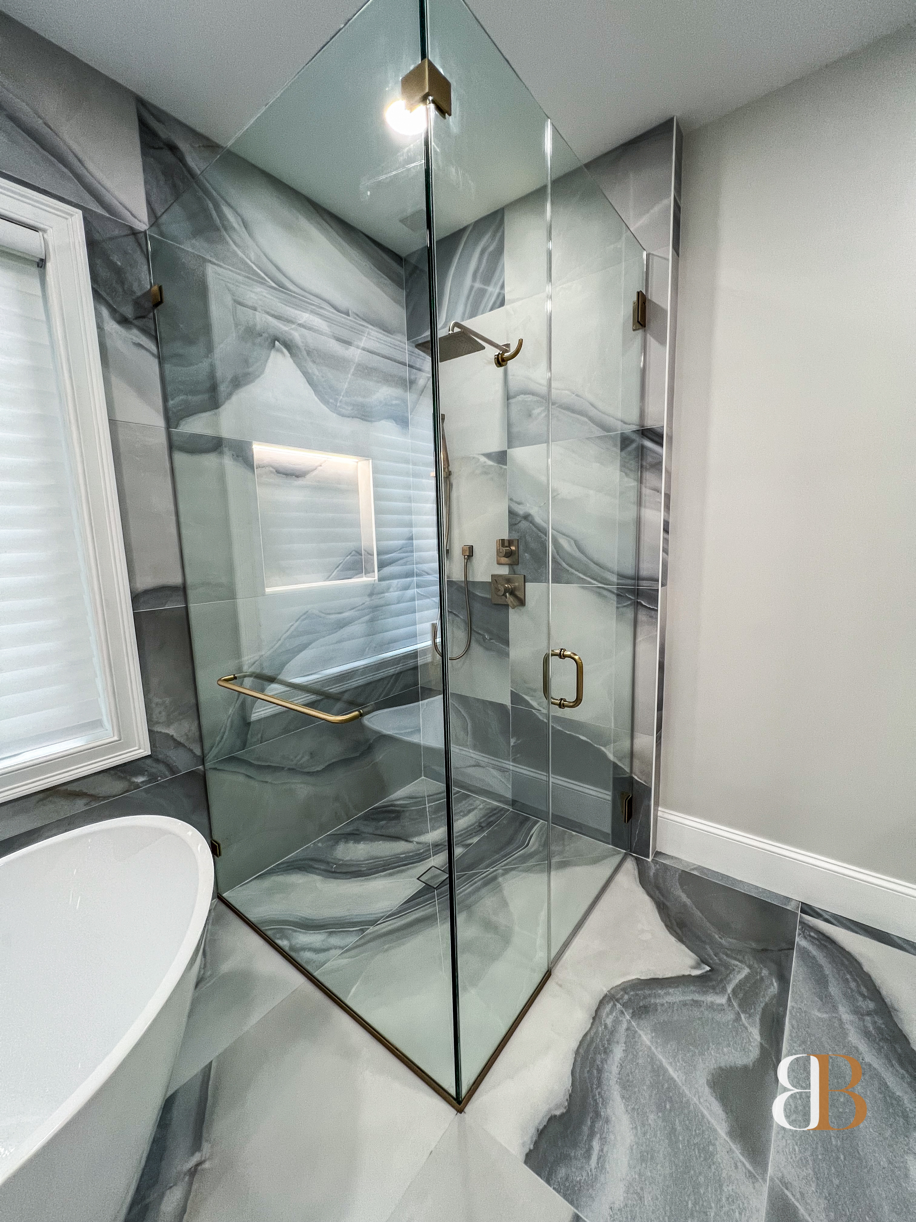 Frameless glass enclosure in a B&B Associates bathroom renovation